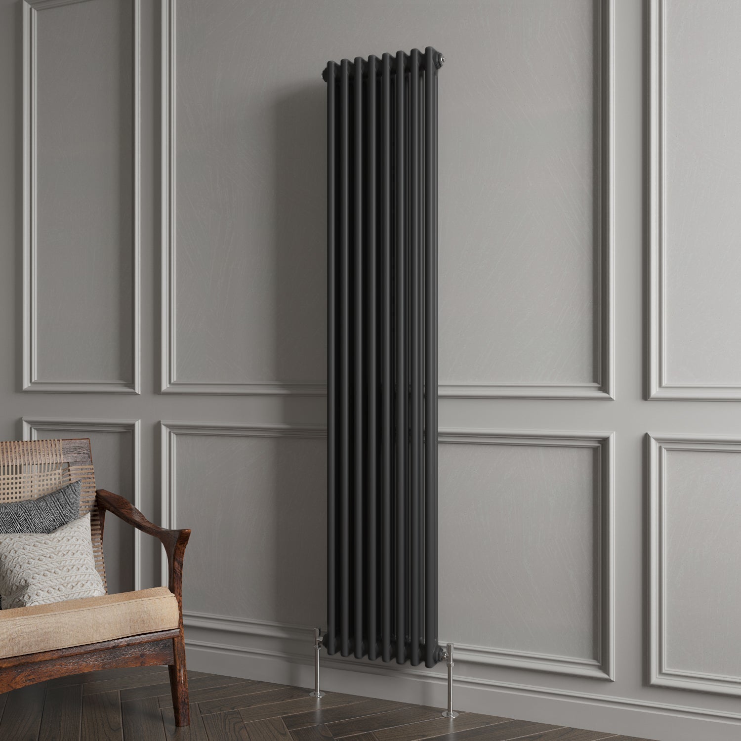 Black vertical radiator against a gray paneled wall with a wooden chair.