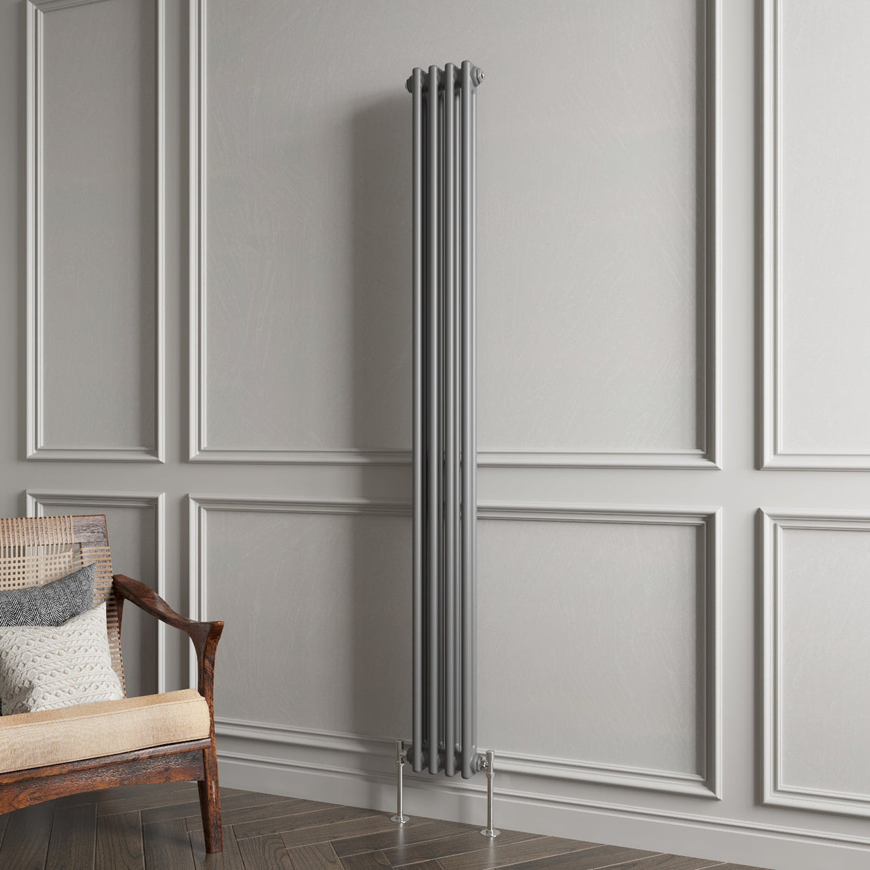Vertical radiator against a gray paneled wall with a wooden chair.