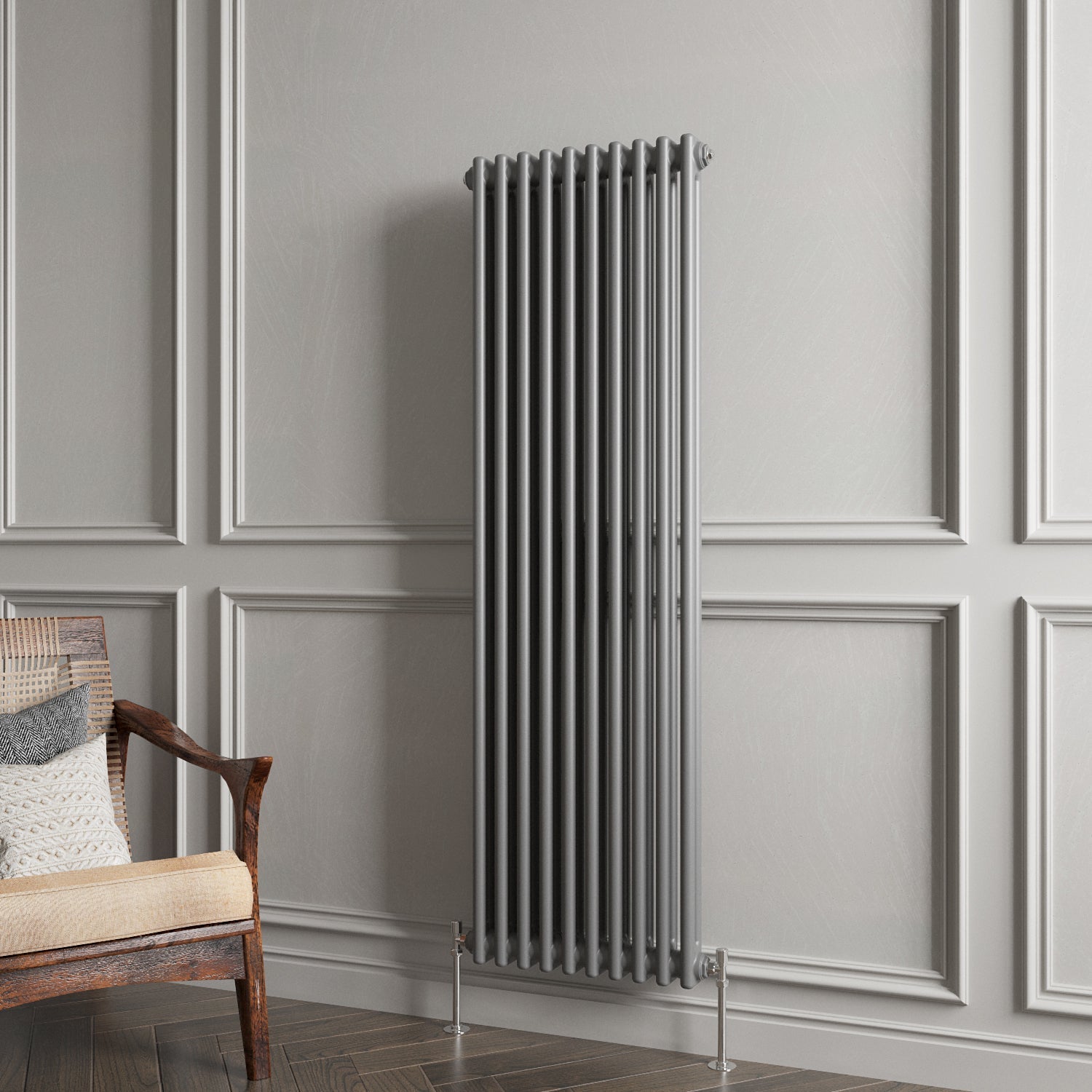 Tall vertical radiator against a gray paneled wall with a wooden chair.