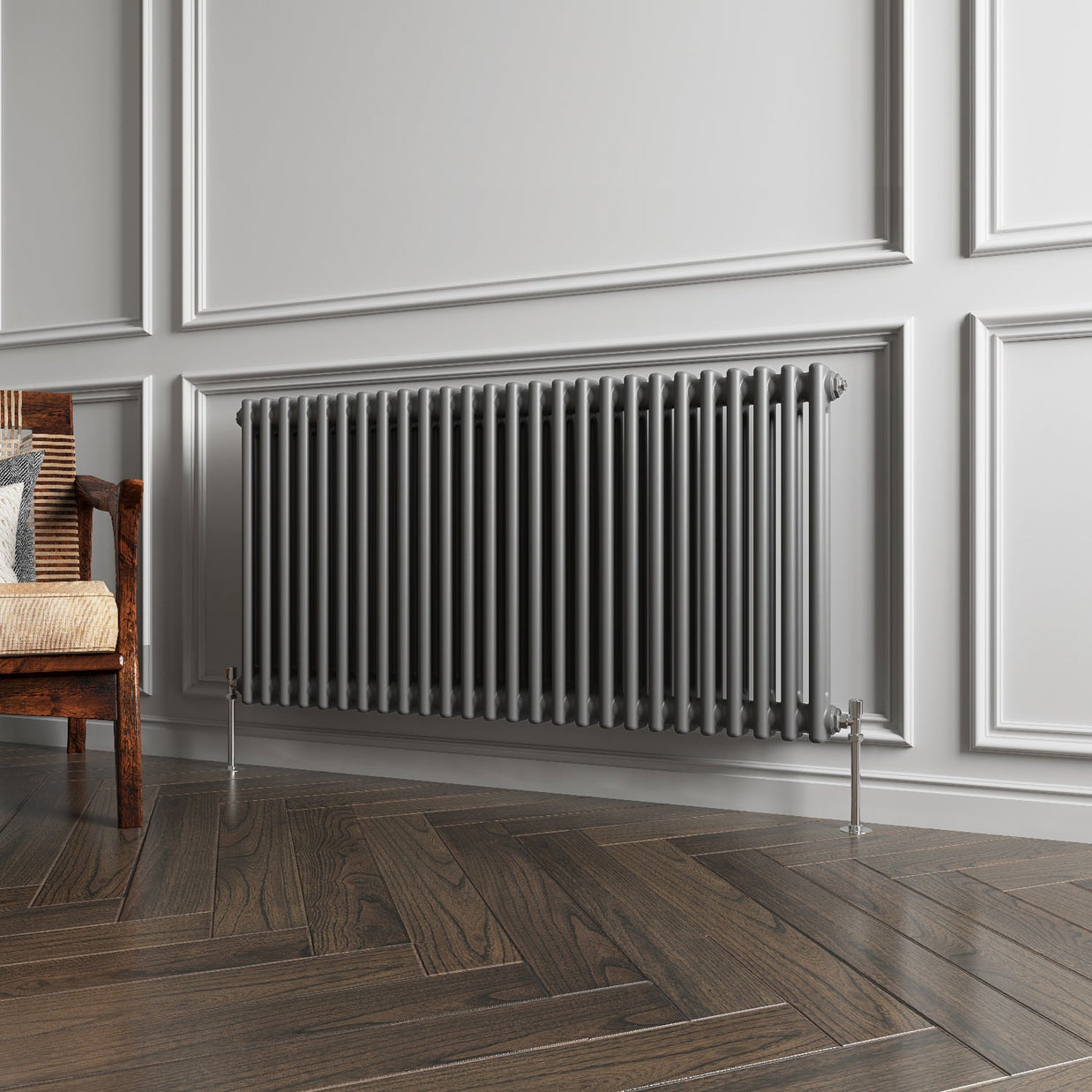 Gray radiator on a wall with wooden flooring and a chair.
