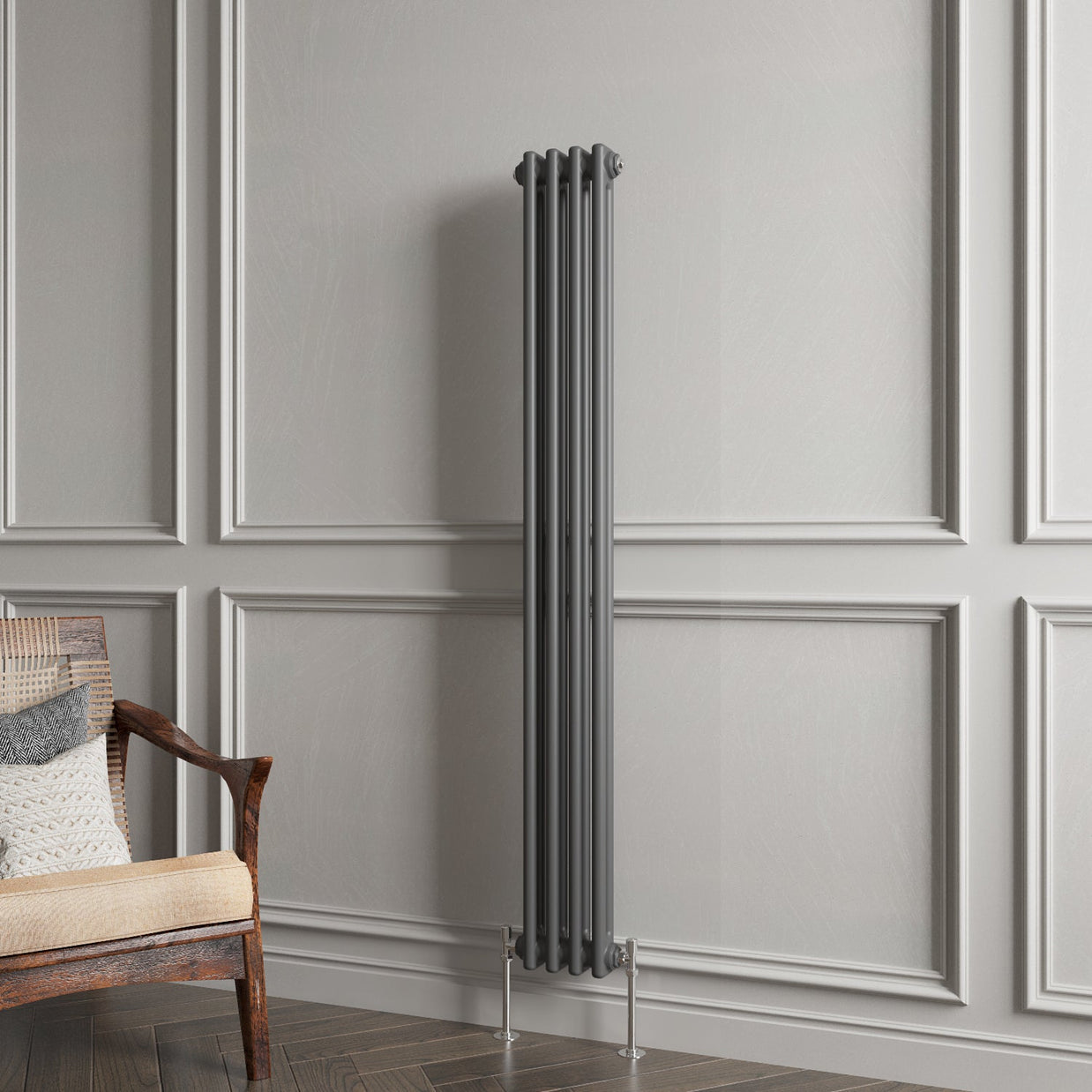 Vertical radiator against a gray paneled wall with a wooden chair.