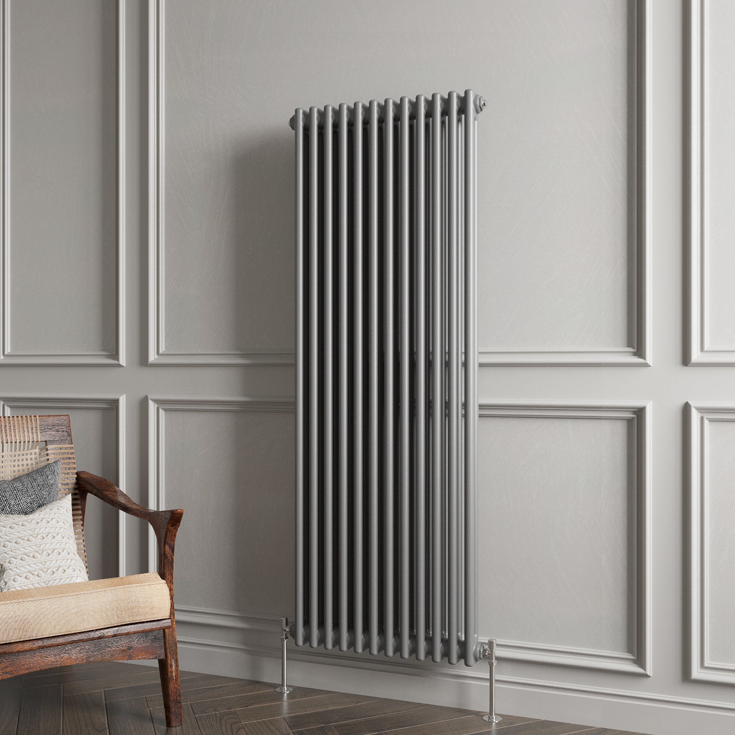 Gray vertical radiator against a gray paneled wall with a wooden chair.