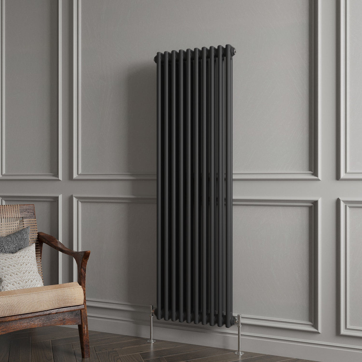 Decorative vertical radiator against a gray paneled wall with a wooden chair.
