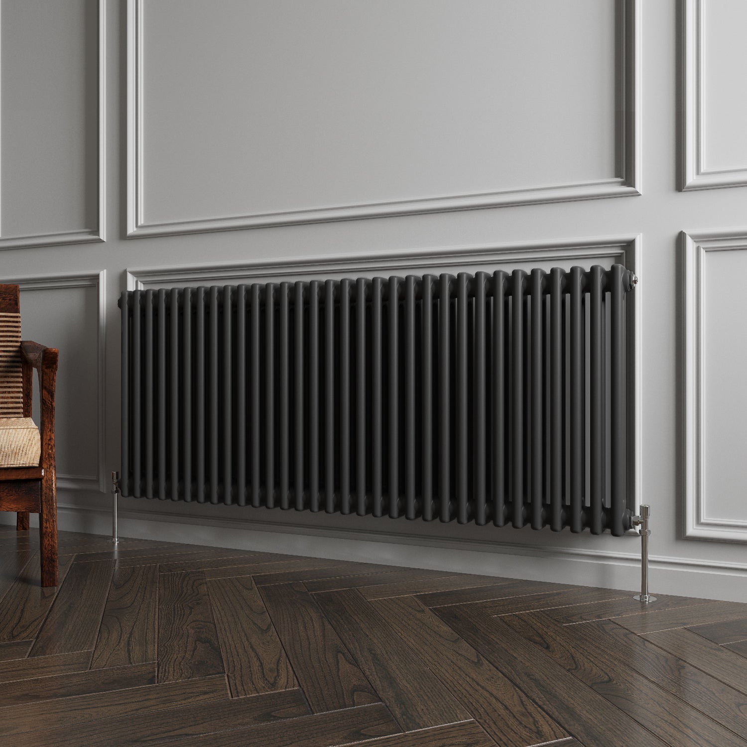 Black radiator on a gray wall with wooden flooring