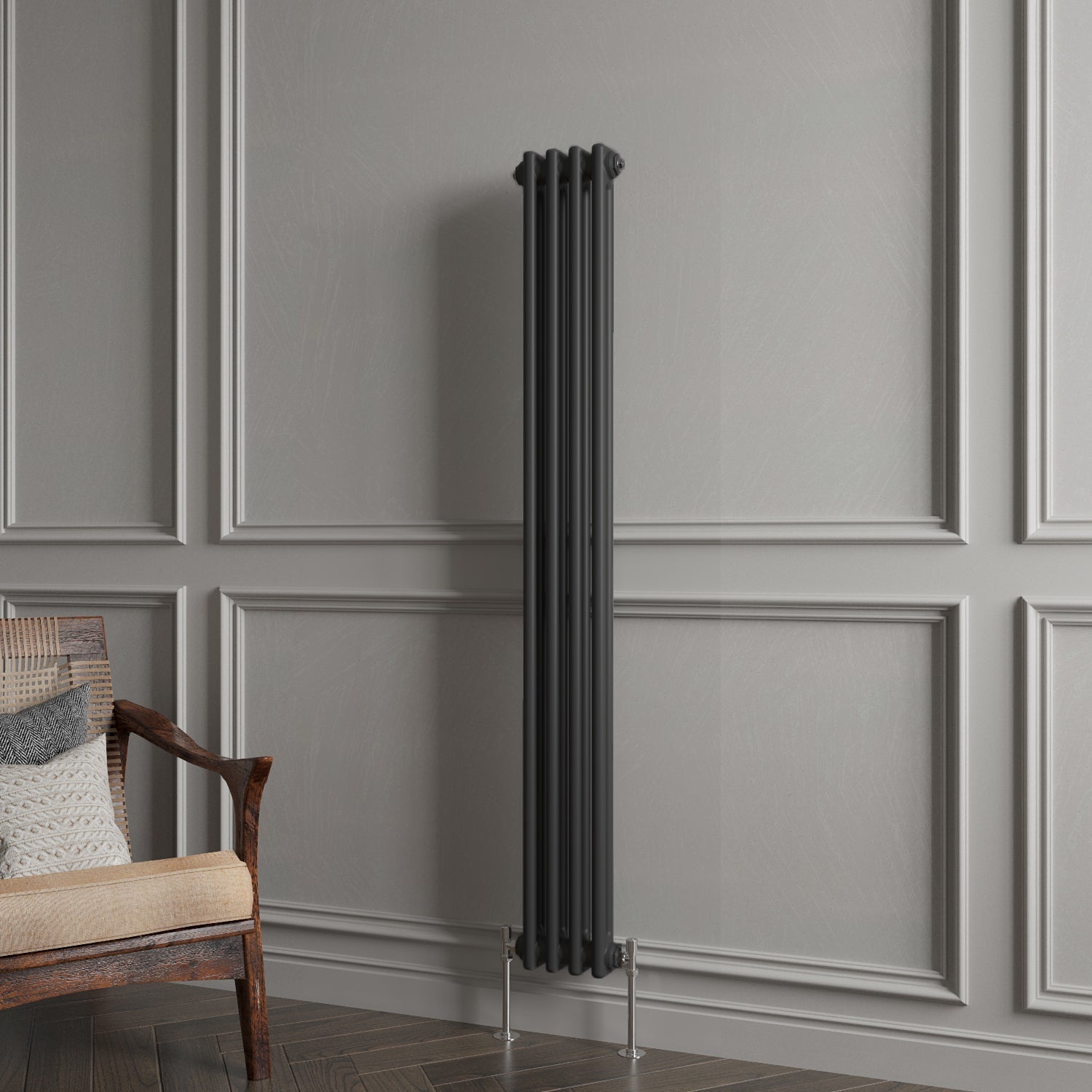 Tall black radiator against a gray paneled wall with a wooden chair.