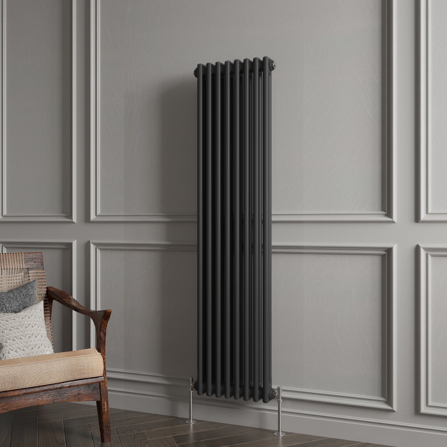 Black radiator against a gray paneled wall with a wooden chair.