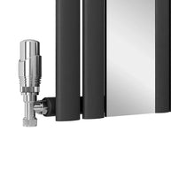 Black radiator with a chrome valve on a white background