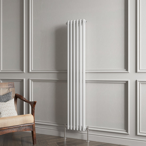 White vertical radiator against a gray paneled wall with a wooden chair.