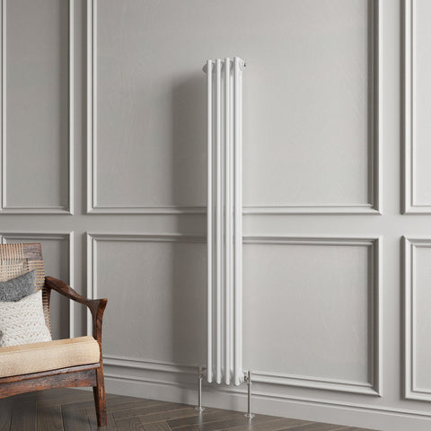 White vertical radiator against a gray paneled wall with a wooden chair.