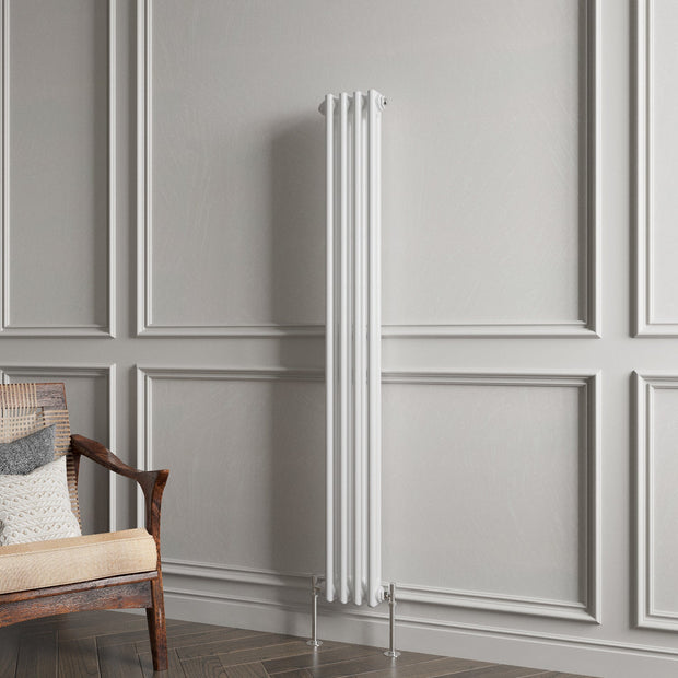 White vertical radiator against a gray paneled wall with a wooden chair.