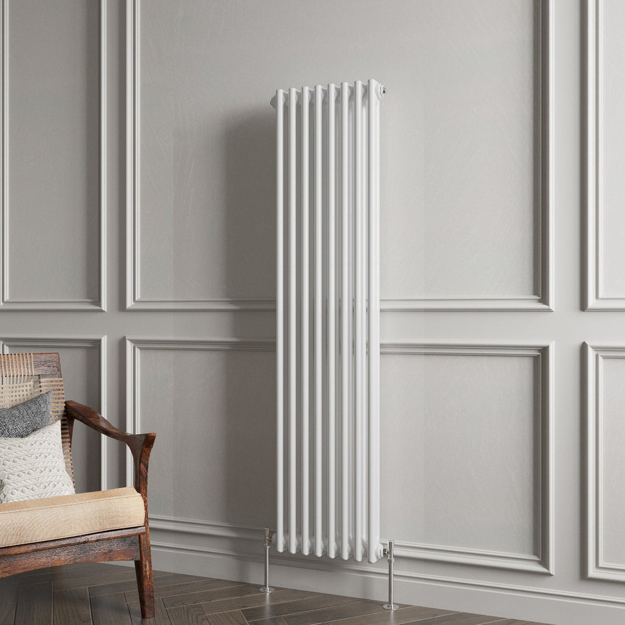 White vertical radiator on a gray paneled wall with a wooden chair.